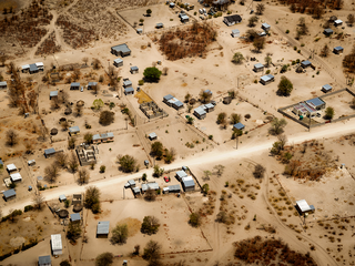 Aerial view of a village on dry land.